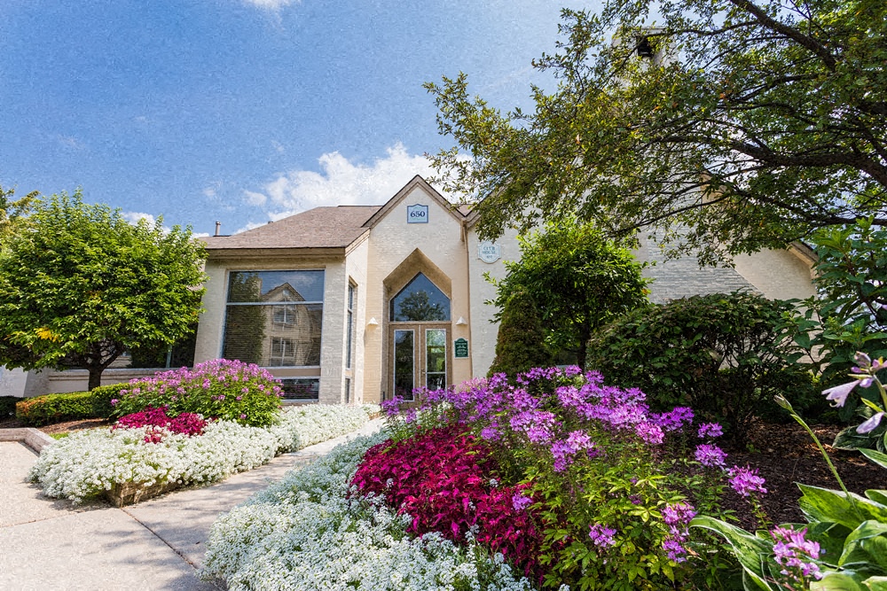 a house with flowers in front of it